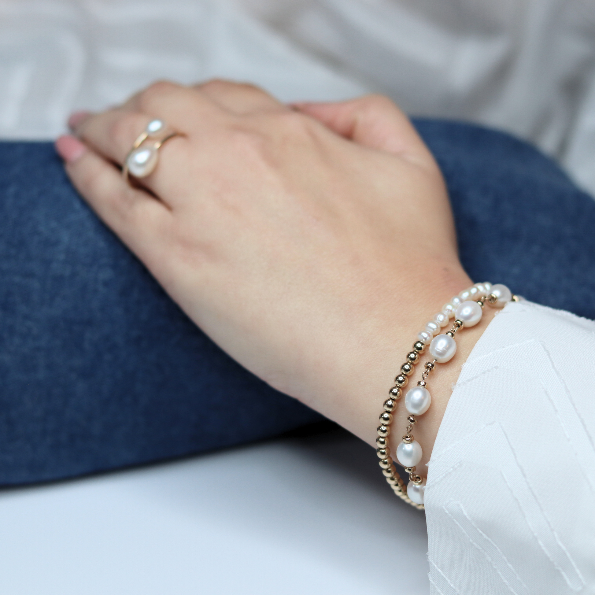 A stunning gold beads and white pearl bracelet, beautifully crafted to enhance any outfit with its refined and classic appeal.