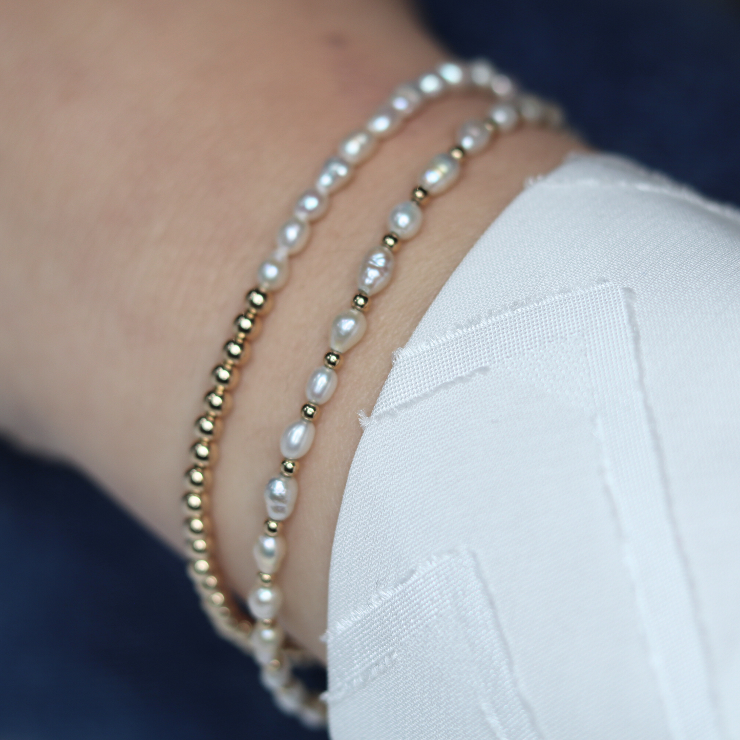 A stunning gold beads and white pearl bracelet, beautifully crafted to enhance any outfit with its refined and classic appeal.