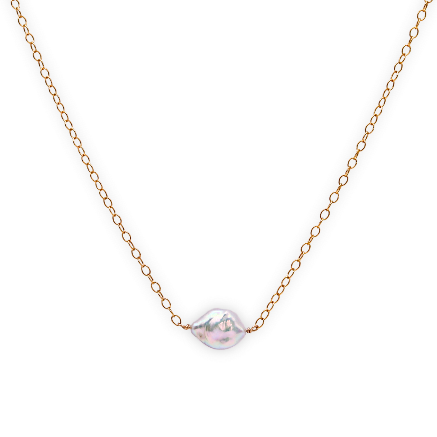 A delicate necklace featuring a baroque pearl elegantly suspended on a gold chain, showcasing timeless beauty.