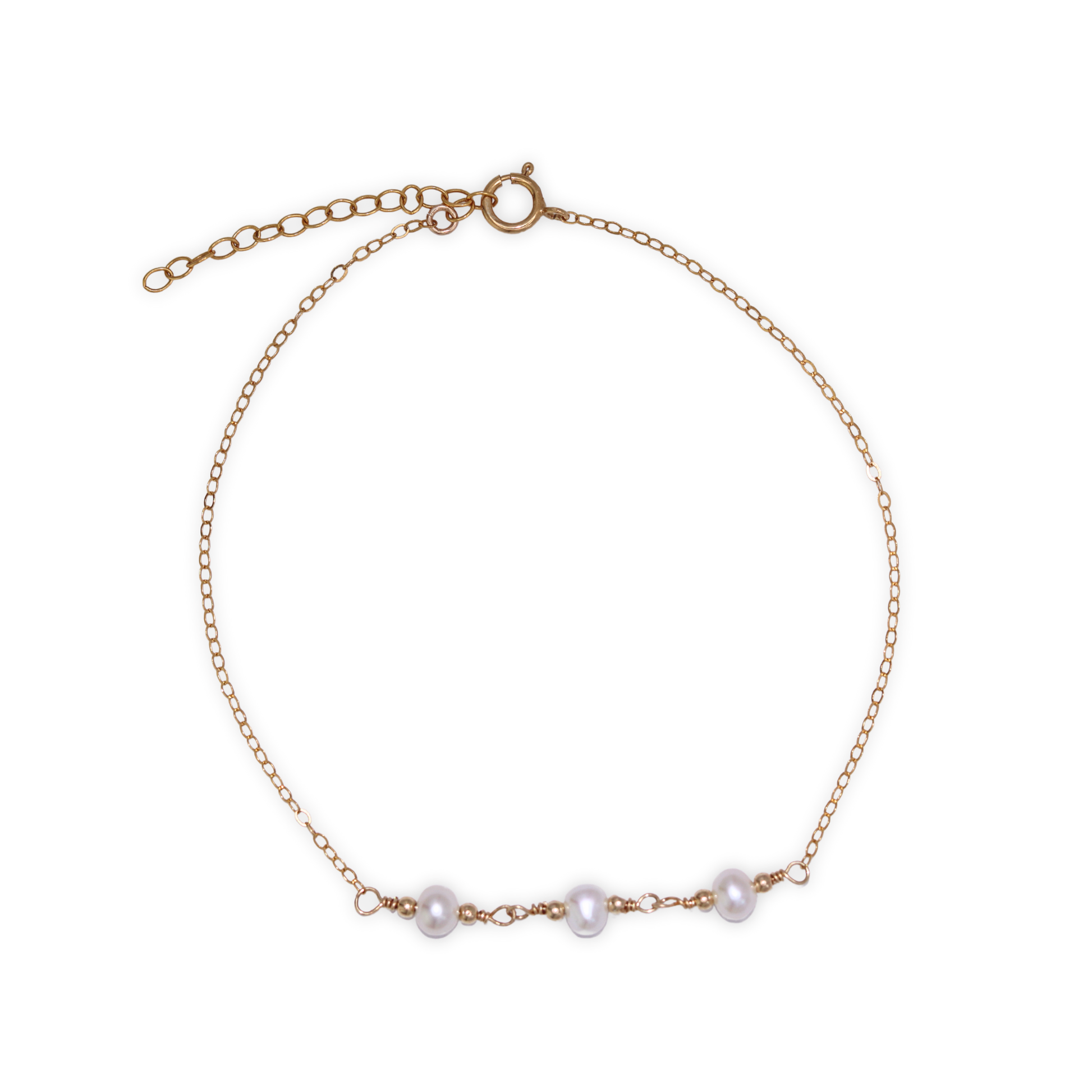A gold chain bracelet adorned with three elegant pearls surrounded by gold beads, showcasing a blend of luxury and sophistication.