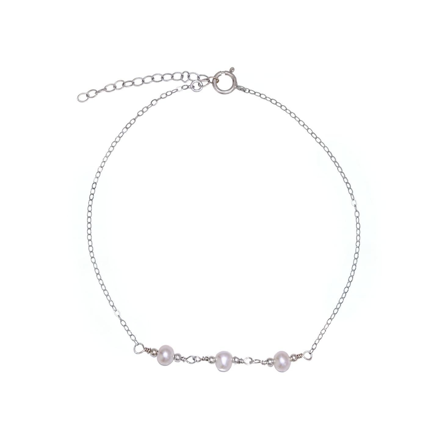 A silver chain bracelet adorned with three elegant pearls surrounded by silver beads, showcasing a blend of luxury and sophistication.