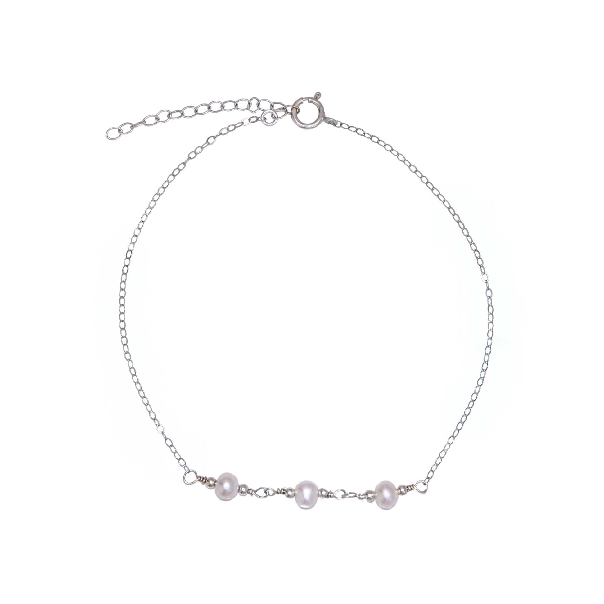 A silver chain bracelet adorned with three elegant pearls surrounded by silver beads, showcasing a blend of luxury and sophistication.