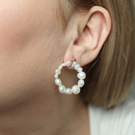 Crafted with a circular style, these earrings feature multi-sized baroque pearls and stud balls for a modern touch.