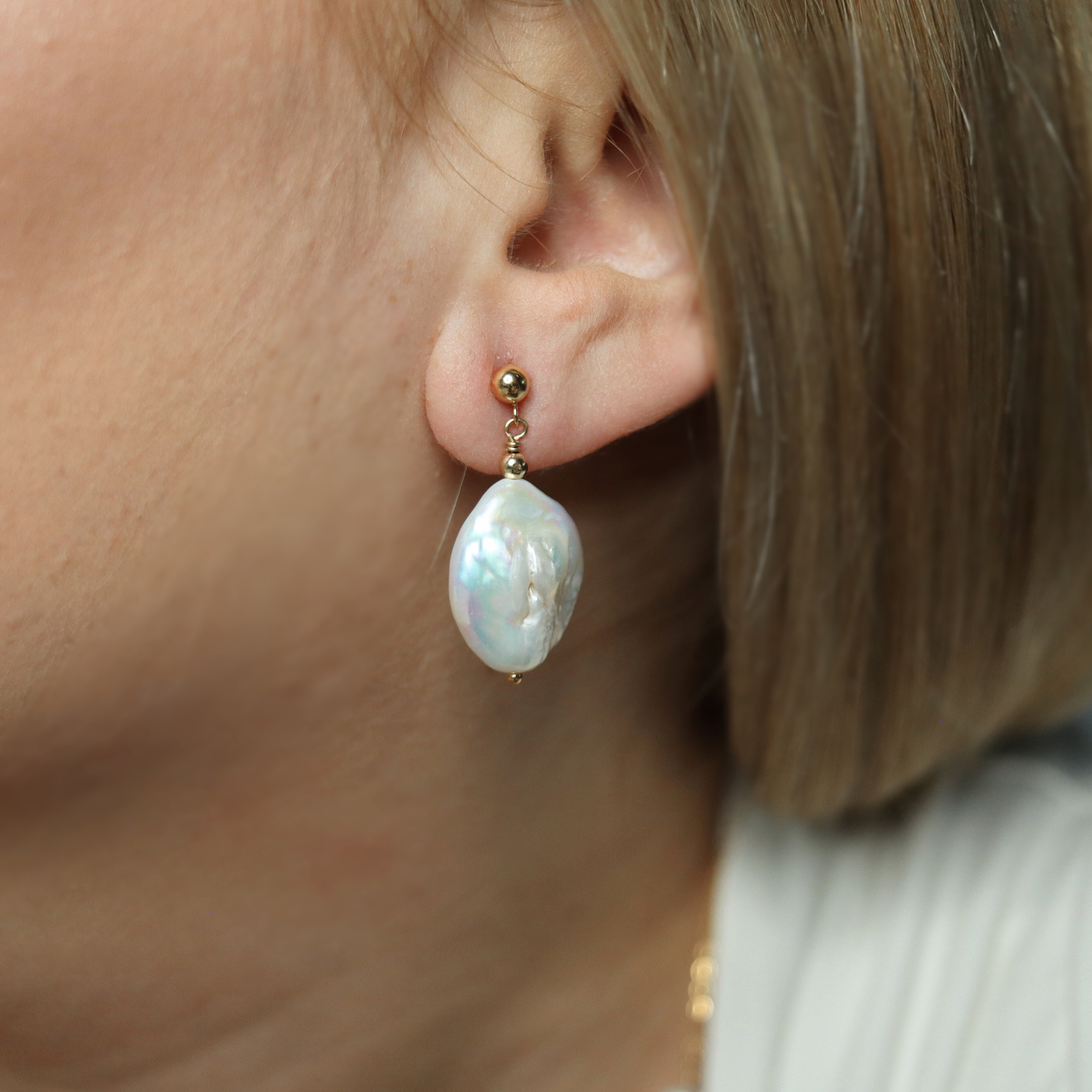 These exquisite earrings feature large baroque pearls delicately suspended from a classic ball stud.