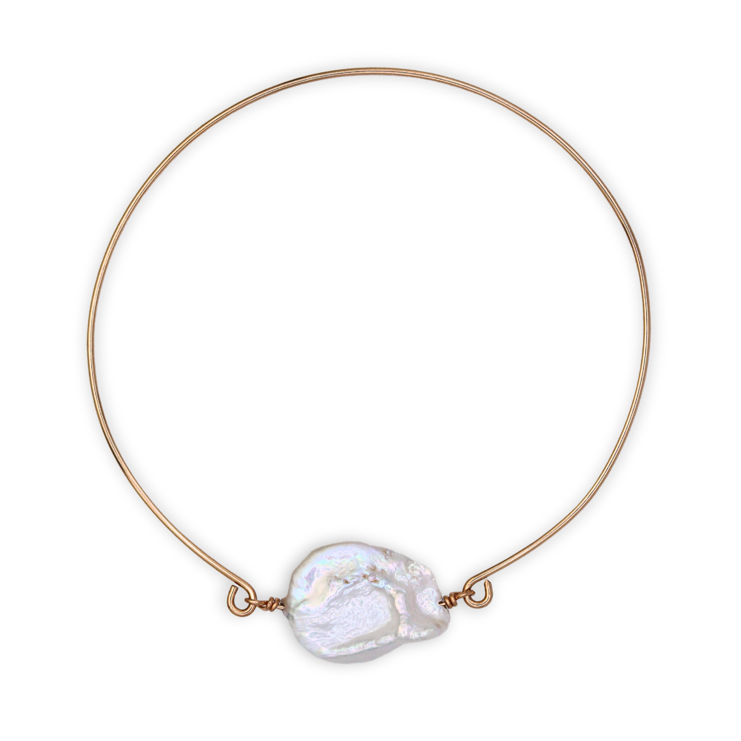 A golden bangle bracelet featuring a single large, baroque pearl, showcasing a blend of luxury and simplicity.