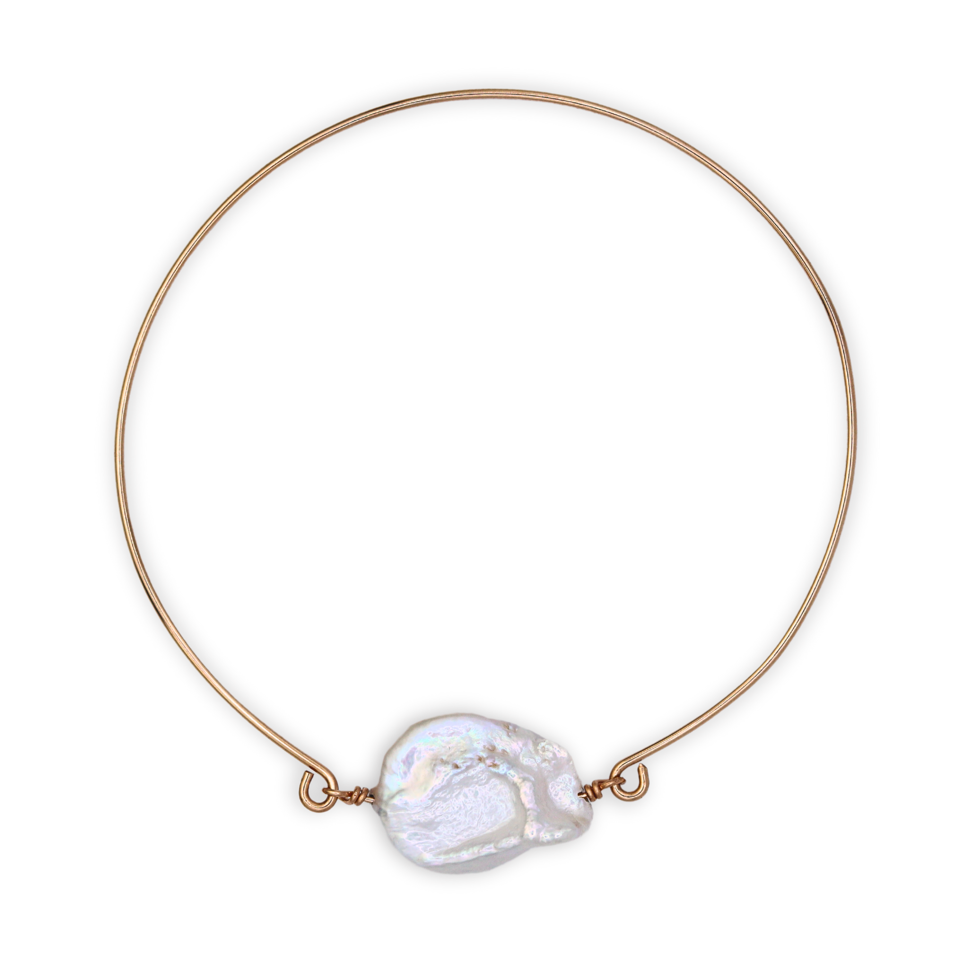 A golden bangle bracelet featuring a single large, baroque pearl, showcasing a blend of luxury and simplicity.