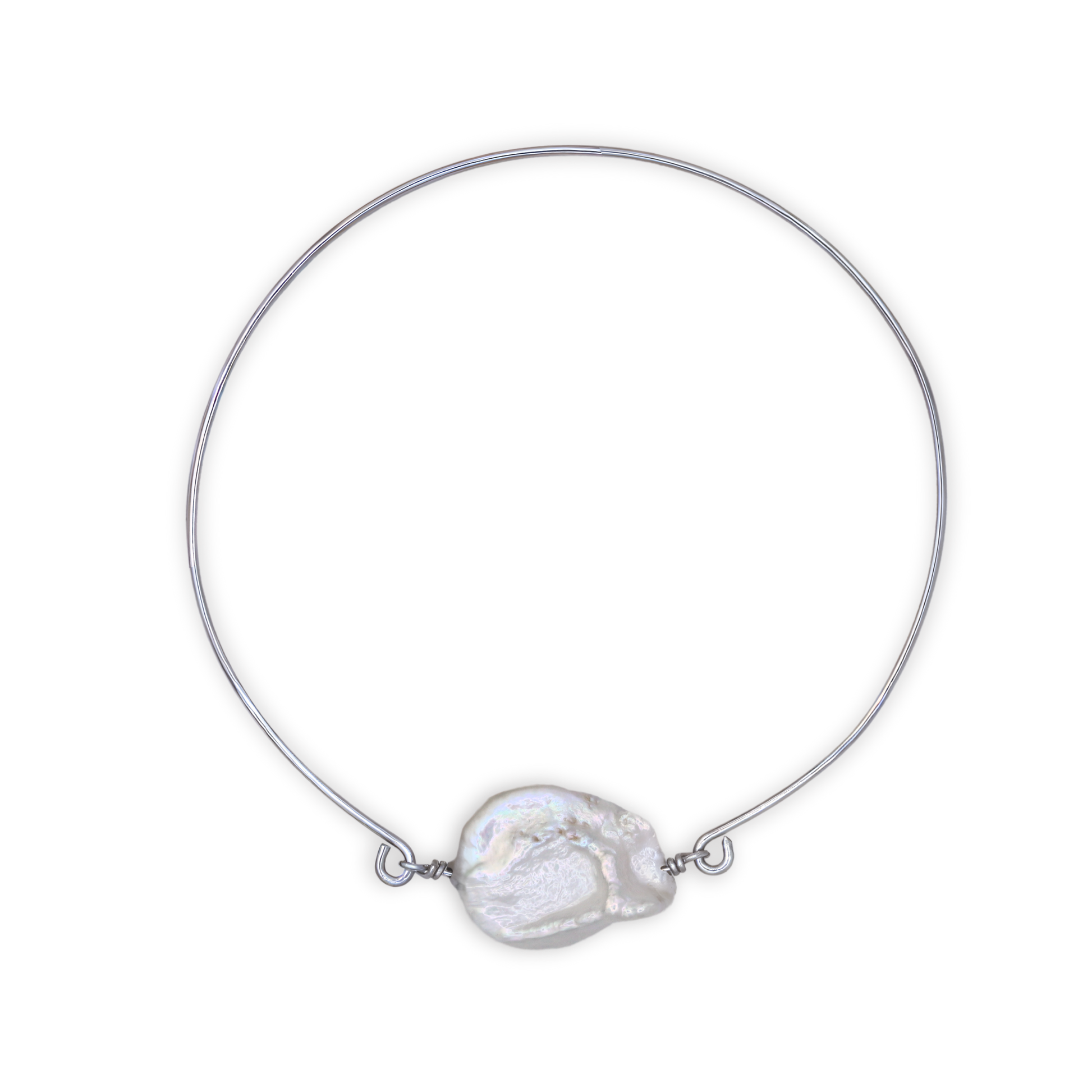 A silver bangle bracelet featuring a single large, baroque pearl, showcasing a blend of luxury and simplicity.