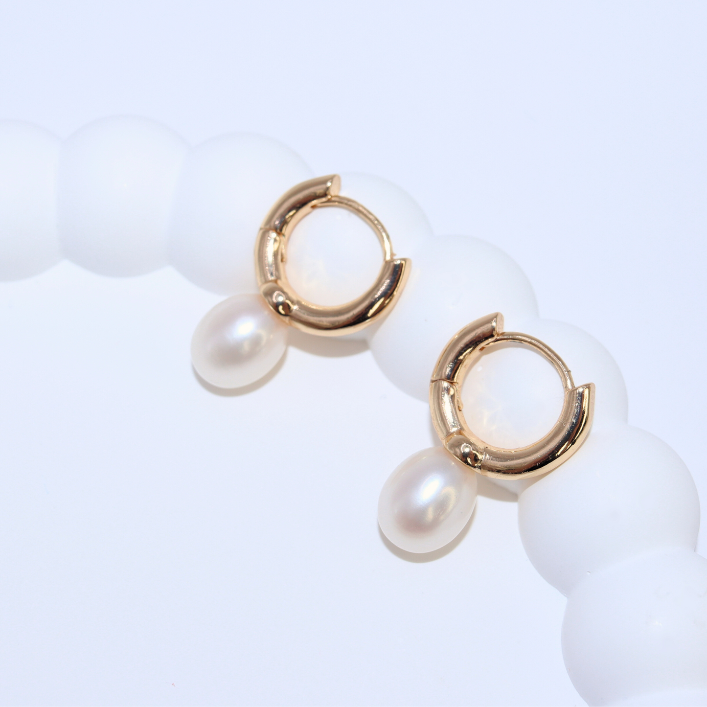 Crafted with exquisite teardrop pearls and hooked for effortless wear, these hoop earrings exude sophistication and luxury.
