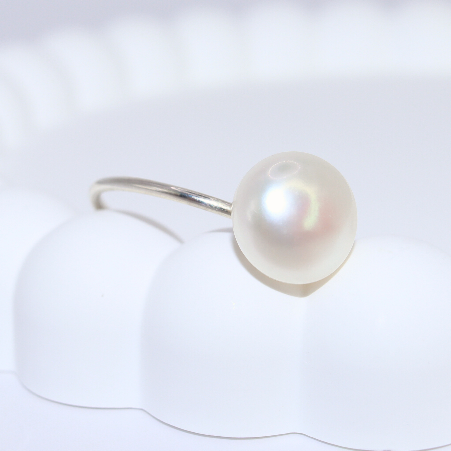 A luxurious silver ring adorned with a large exquisite pearl, radiating elegance and timeless beauty.