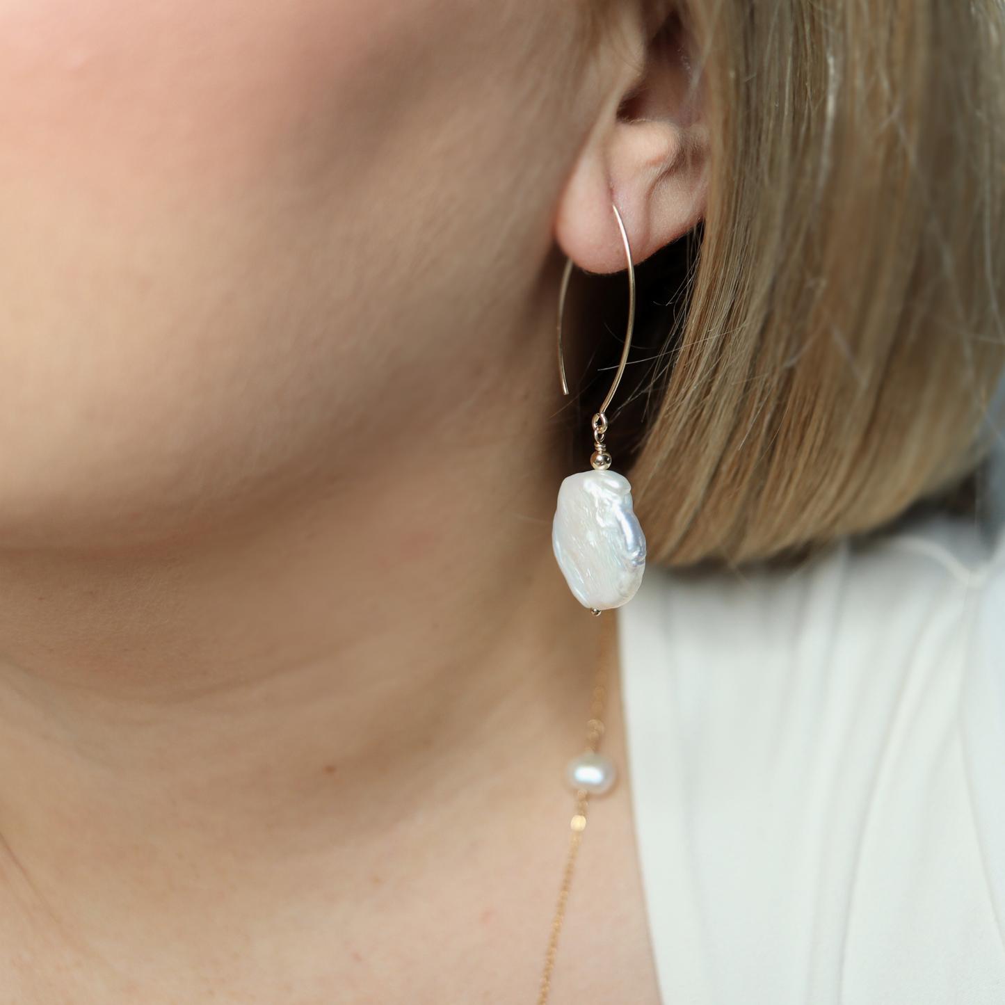 Featuring stunning large baroque pearls and an elegant V-shaped design, these earrings will elevate any outfit with a touch of sophistication and refinement.