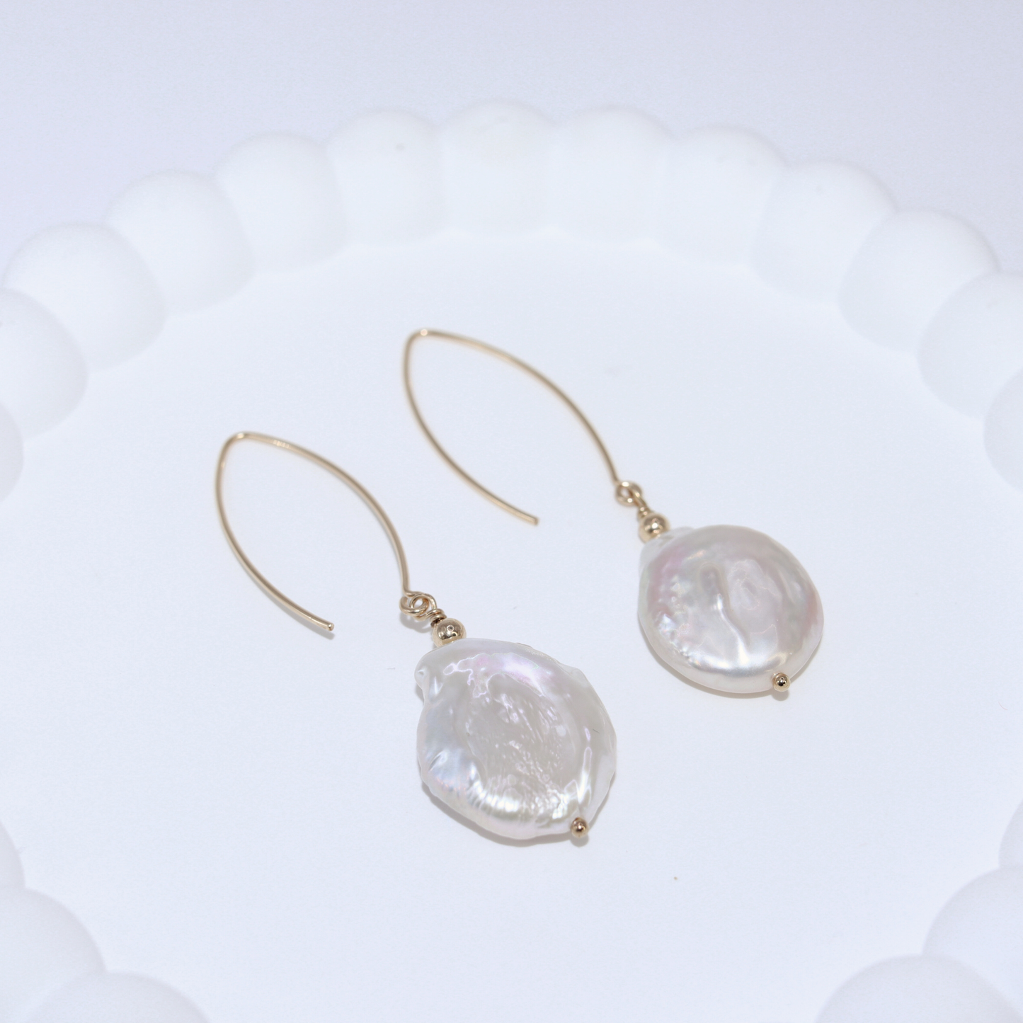 Featuring stunning large baroque pearls and an elegant V-shaped design, these earrings will elevate any outfit with a touch of sophistication and refinement.
