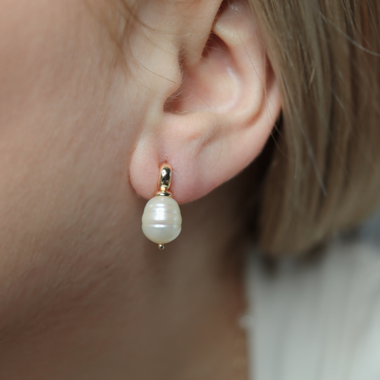 Each stud features a unique, irregularly-shaped rice pearl, adding a touch of sophistication and luxury to your look.