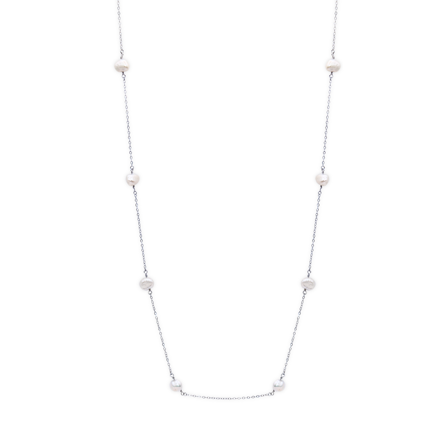 A long necklace featuring an elegant arrangement of ivory baroque pearls, showcasing a sophisticated design.