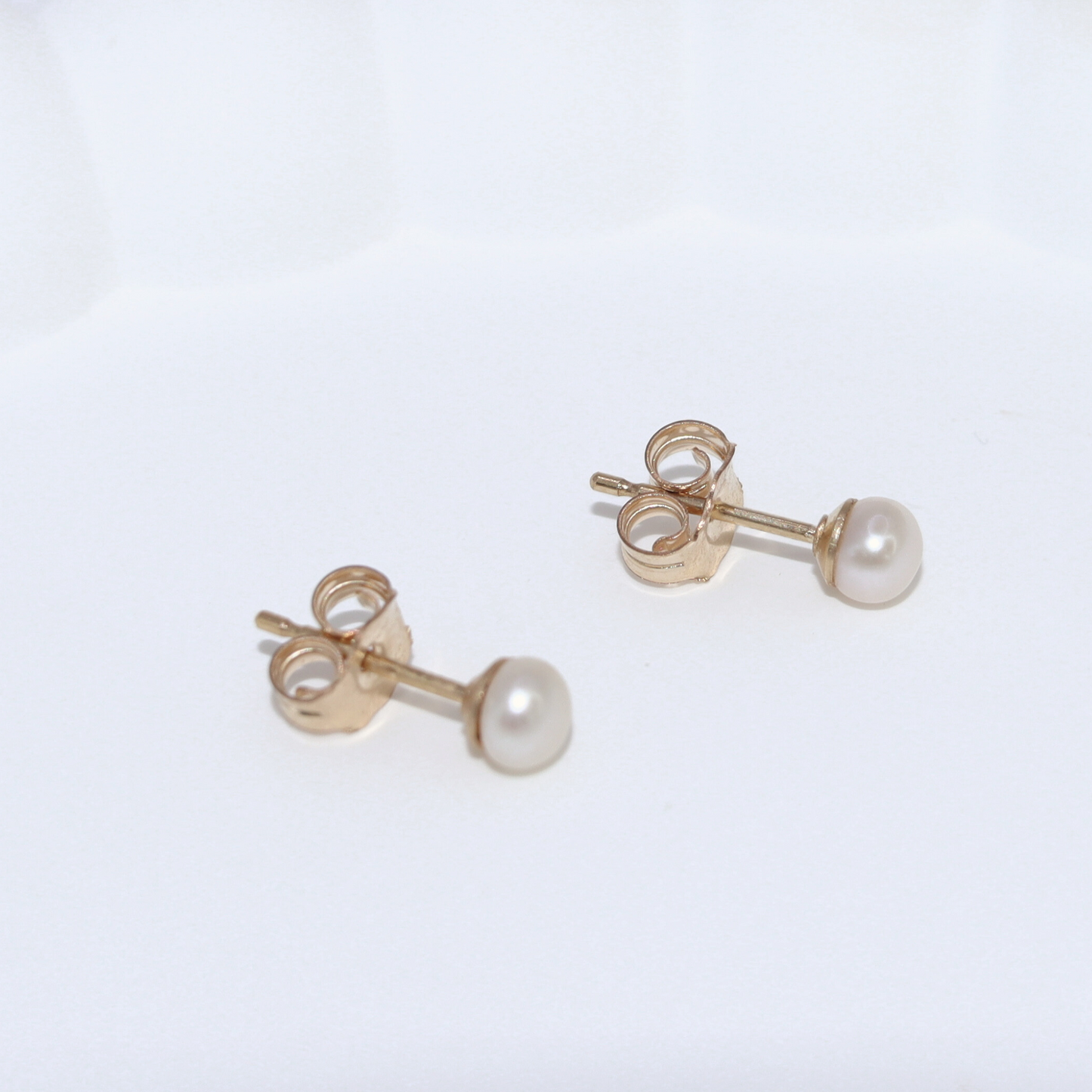 3mm pearl studs that add a touch of sophistication to any outfit