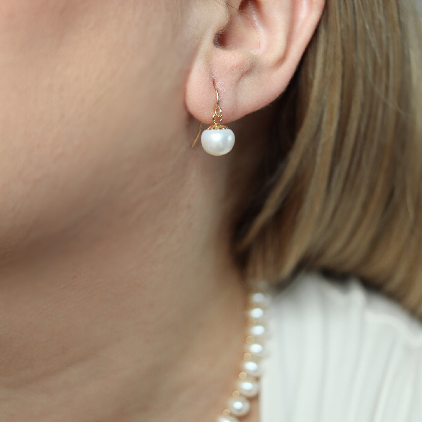 The single drop pearl adds a touch of sophistication and refinement, making these earrings a must-have for any fashion-forward individual.