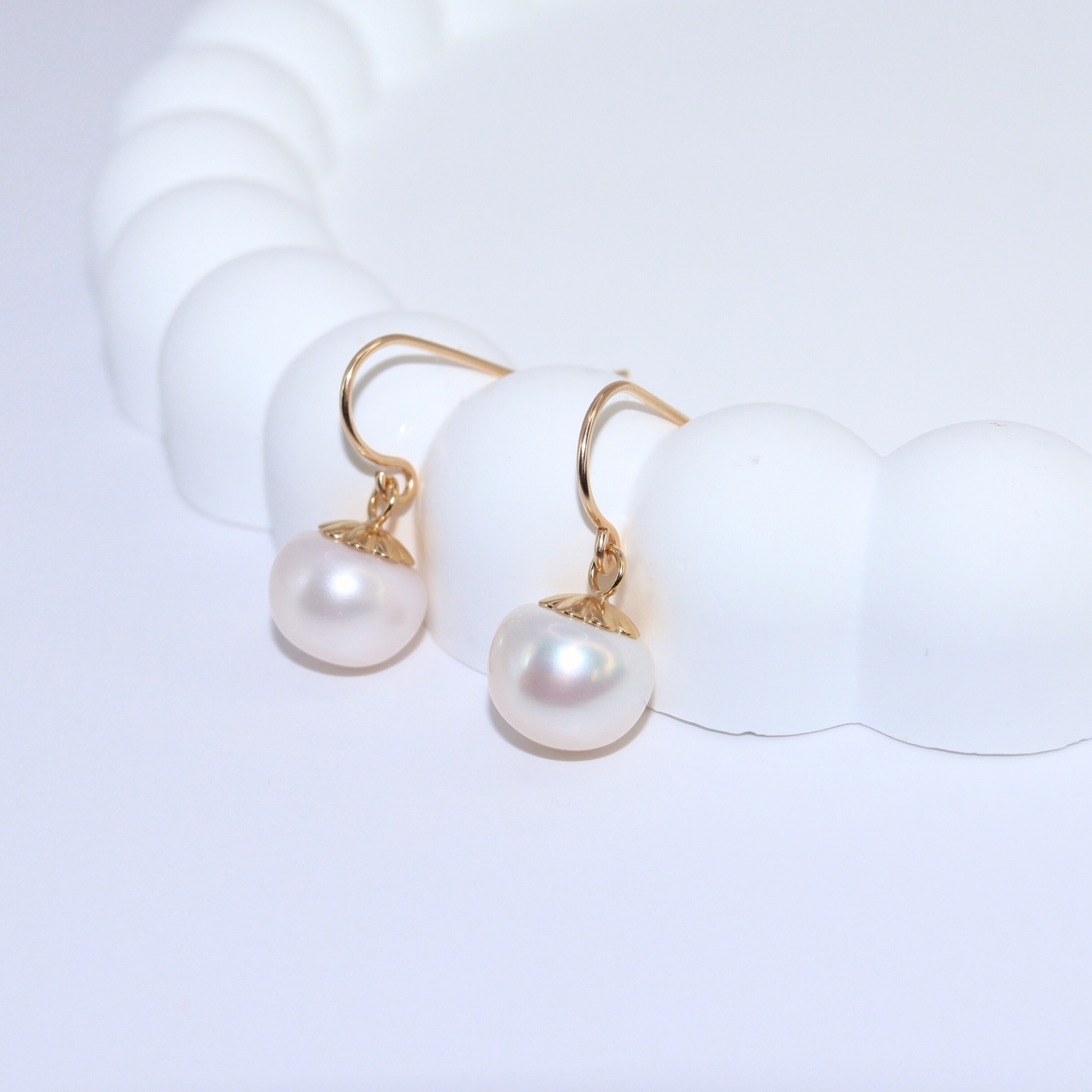 The single drop pearl adds a touch of sophistication and refinement, making these earrings a must-have for any fashion-forward individual.