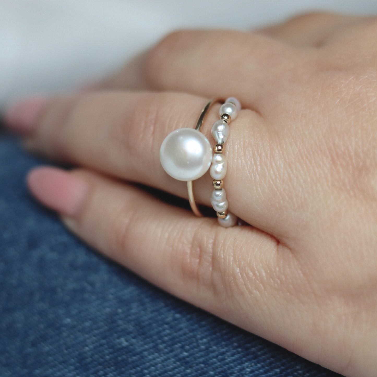 A luxurious white pearl ring embellished with radiant gold beads, perfect for adding a touch of elegance to any ensemble.
