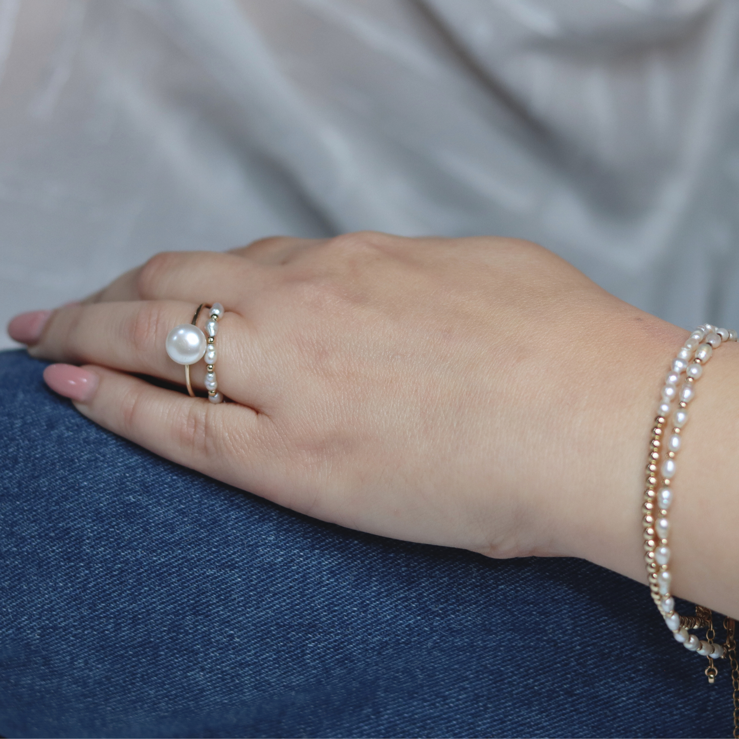 A luxurious white pearl ring embellished with radiant gold beads, perfect for adding a touch of elegance to any ensemble.