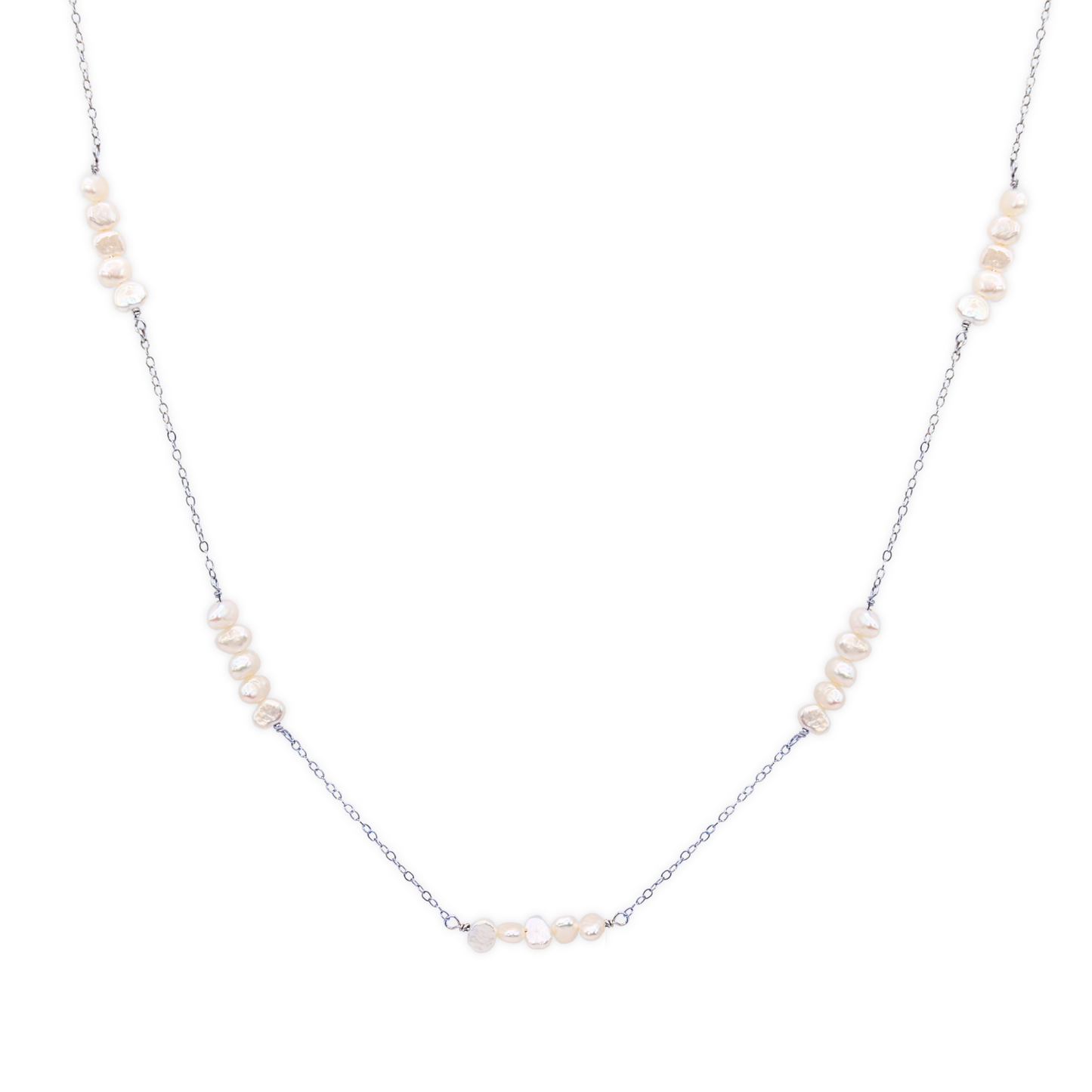 A delicate chain necklace featuring clusters of four small, lustrous pearls elegantly arranged along its length.