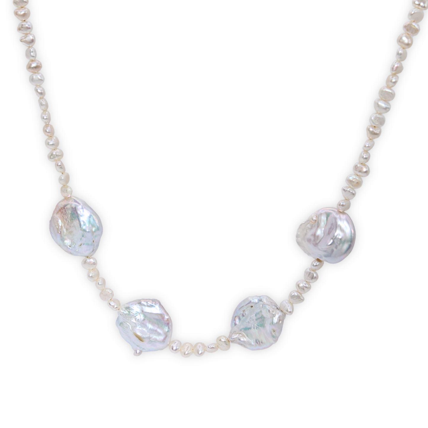 An exquisite white pearl necklace adorned with seed pearls and four prominent baroque pearls, showcasing refined elegance.