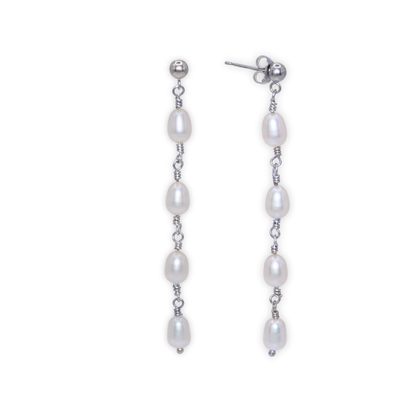 Elegant silver and four ivory pearl drop earrings, exuding sophistication and timeless beauty, perfect for any luxurious occasion.