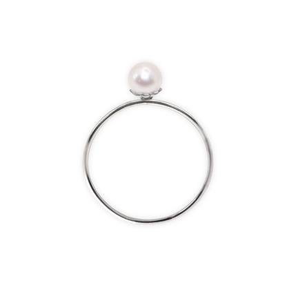 An exquisite silver ring featuring a single, lustrous pearl set on a flower base, embodying sophistication and grace.
