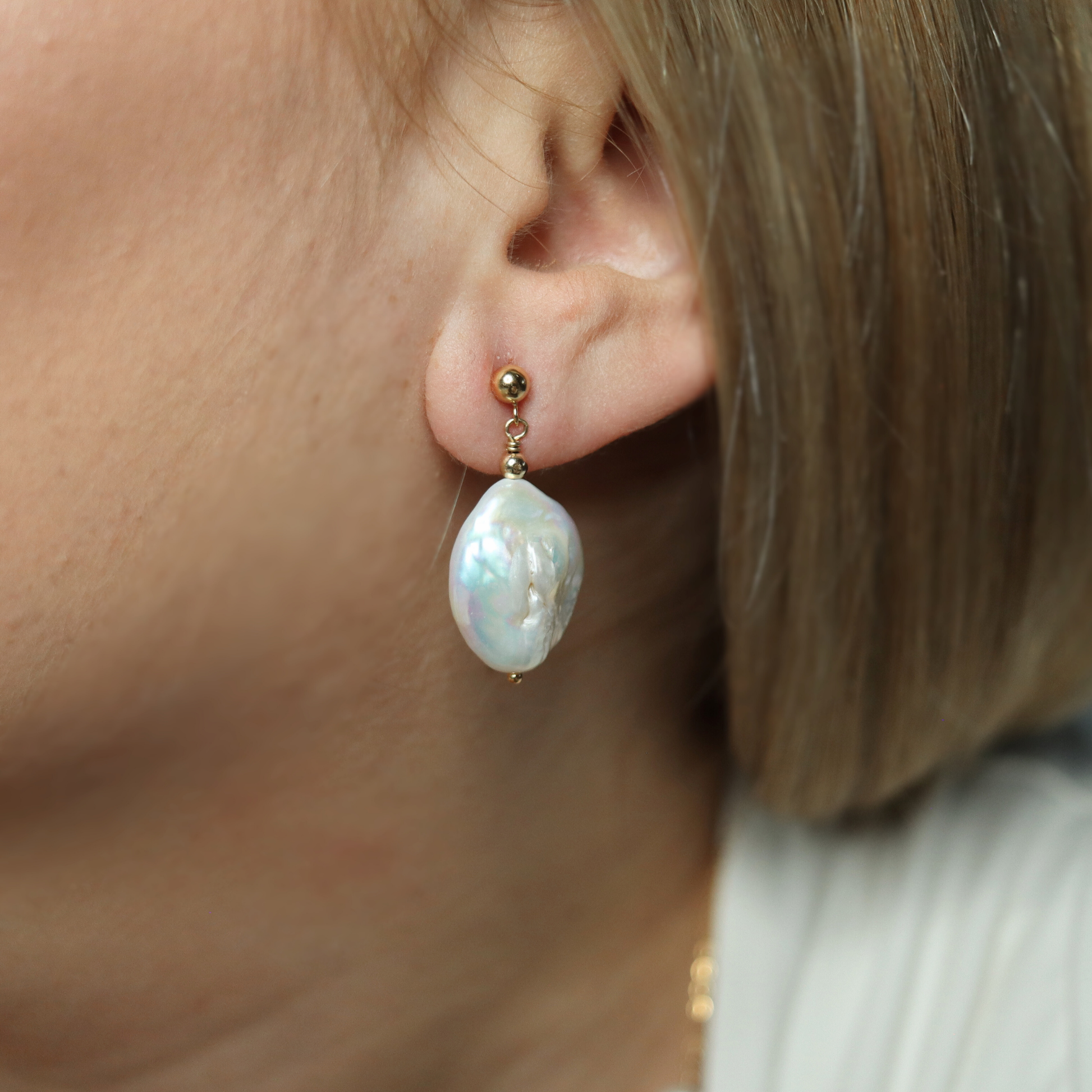  These exquisite earrings feature large baroque pearls delicately suspended from a classic ball stud. 