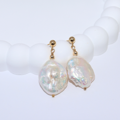  These exquisite earrings feature large baroque pearls delicately suspended from a classic ball stud. 