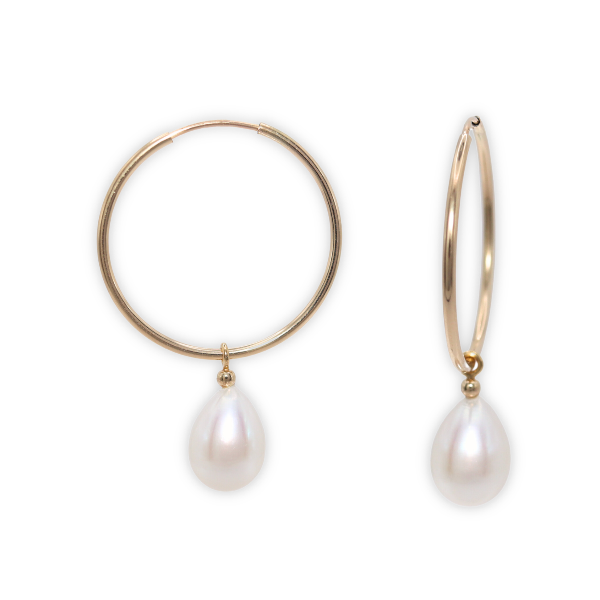  These sophisticated hoop earrings feature a single teardrop pearl, adding a touch of elegance to any outfit. 
