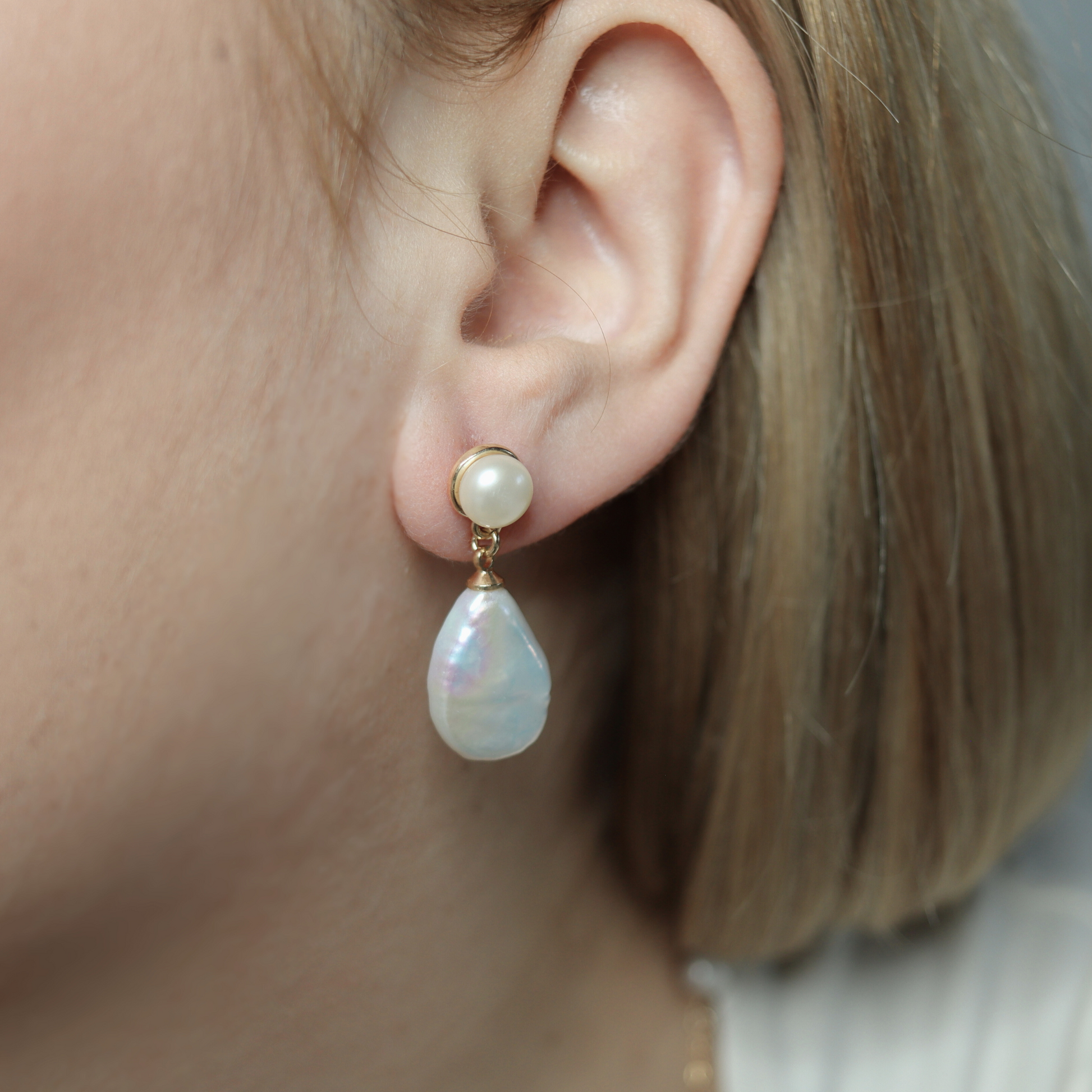 Featuring pearl studs and flat teardrop dangles, these earrings exude elegance and sophistication.