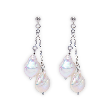Featuring stunning baroque pearls dangling on dainty chains, these earrings exude elegance and luxury.
