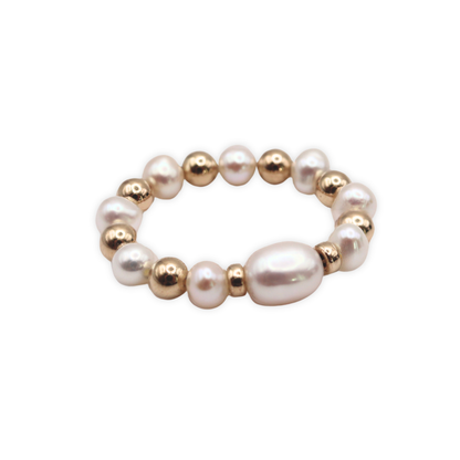 Exquisite gold beads and white pearl ring, a timeless accessory that embodies elegance and refined style.